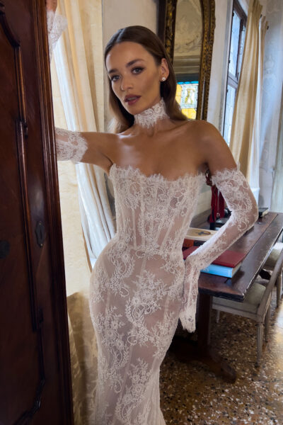 Close-up of off shoulder lace mermaid wedding dress with sheer corset