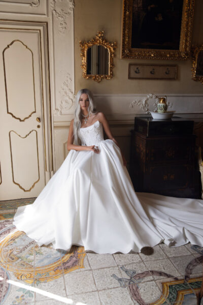Bride in satin corset wedding dress with poodles